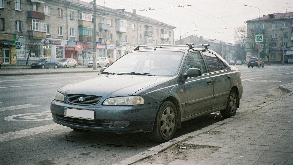 Compact sedan from the economy class parked on a city street before an intercity trip